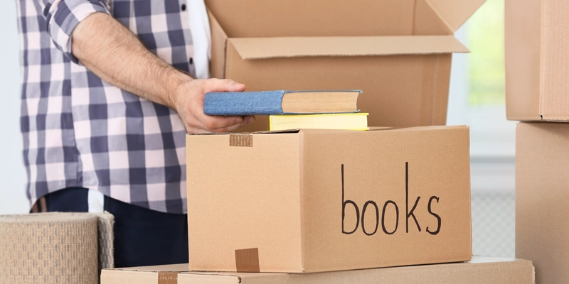 packing books into small size moving box